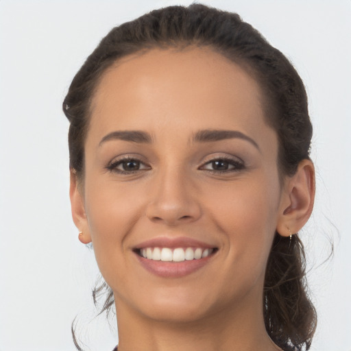 Joyful white young-adult female with long  brown hair and brown eyes