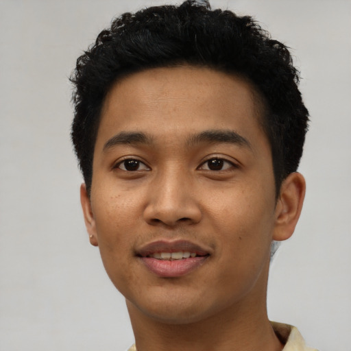 Joyful latino young-adult male with short  black hair and brown eyes