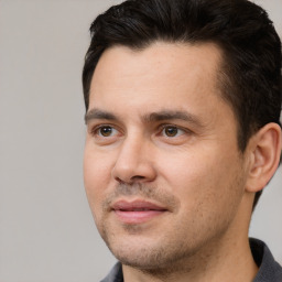 Joyful white adult male with short  black hair and brown eyes