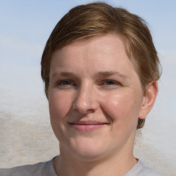 Joyful white young-adult female with medium  brown hair and blue eyes