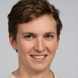 Joyful white young-adult female with short  brown hair and grey eyes