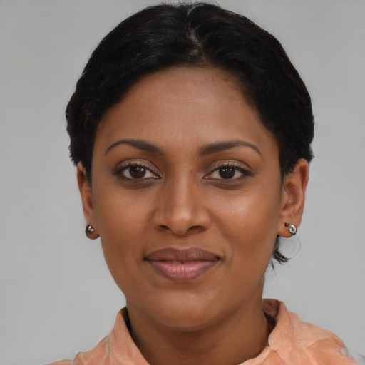 Joyful latino young-adult female with short  black hair and brown eyes
