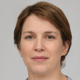 Joyful white adult female with medium  brown hair and grey eyes