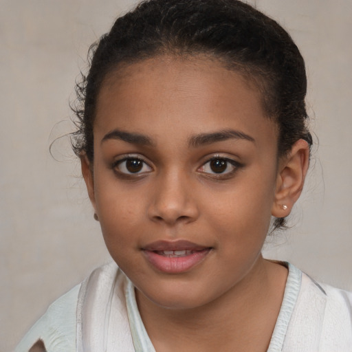 Joyful latino child female with short  brown hair and brown eyes