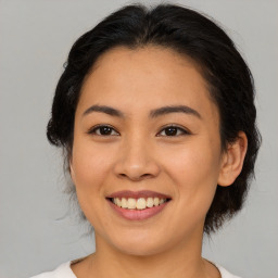 Joyful asian young-adult female with medium  brown hair and brown eyes