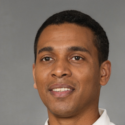 Joyful black young-adult male with short  black hair and brown eyes