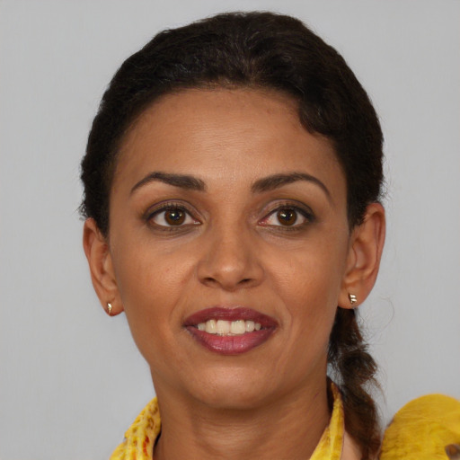 Joyful latino adult female with short  brown hair and brown eyes