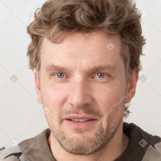 Joyful white adult male with short  brown hair and grey eyes