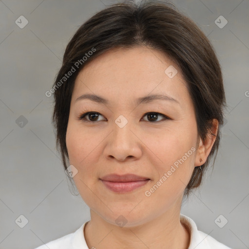 Joyful asian adult female with medium  brown hair and brown eyes