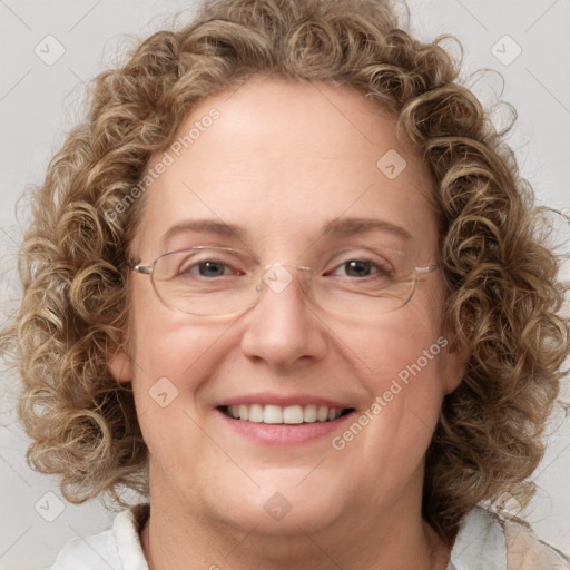 Joyful white adult female with medium  brown hair and blue eyes