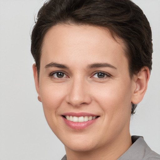 Joyful white young-adult female with short  brown hair and brown eyes