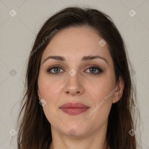 Joyful white adult female with long  brown hair and brown eyes