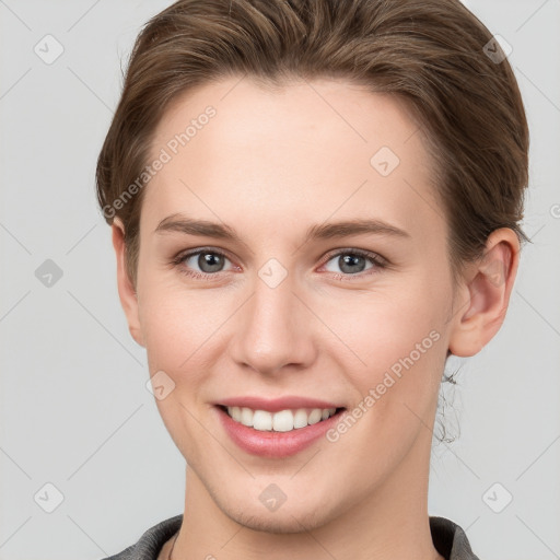 Joyful white young-adult female with short  brown hair and grey eyes