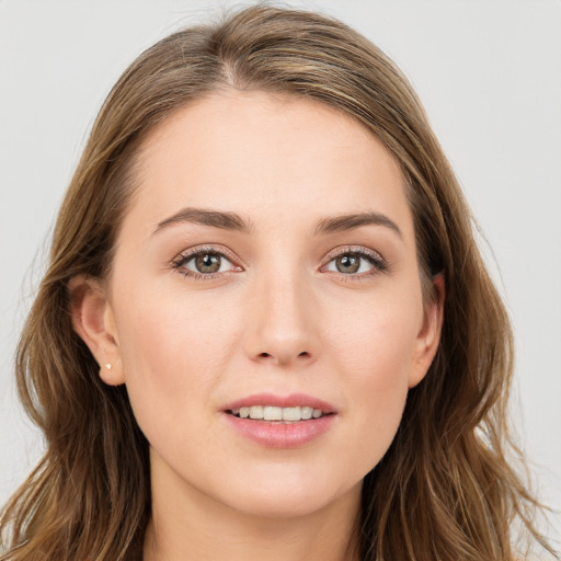 Joyful white young-adult female with long  brown hair and blue eyes