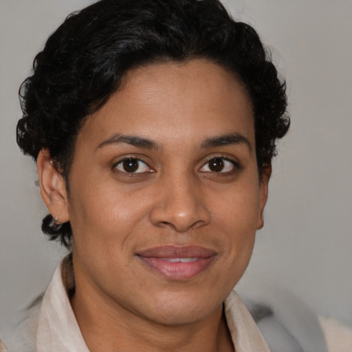 Joyful latino young-adult female with short  brown hair and brown eyes
