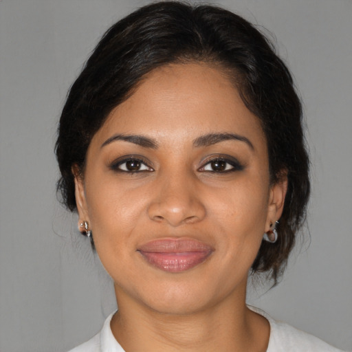 Joyful black young-adult female with medium  brown hair and brown eyes