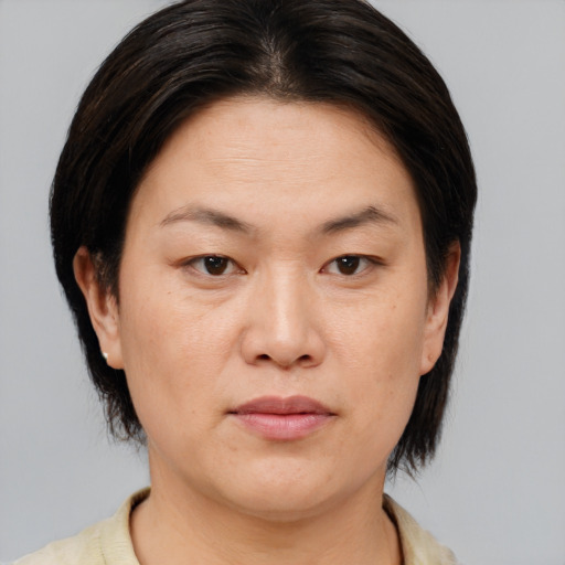 Joyful white adult female with medium  brown hair and brown eyes