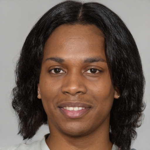 Joyful black young-adult female with medium  black hair and brown eyes