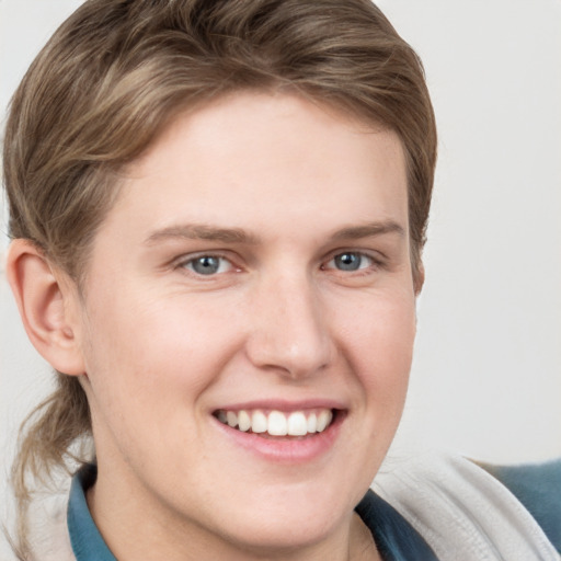 Joyful white young-adult female with short  brown hair and grey eyes