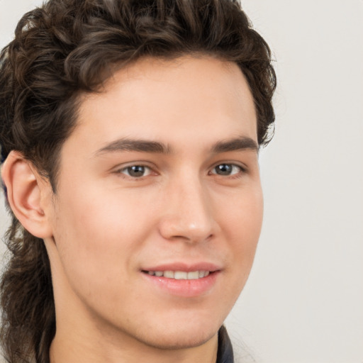 Joyful white young-adult male with medium  brown hair and brown eyes