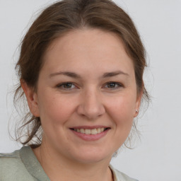 Joyful white young-adult female with medium  brown hair and brown eyes