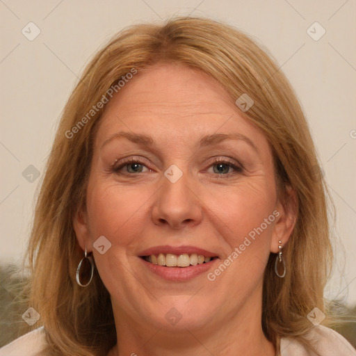 Joyful white adult female with medium  brown hair and blue eyes