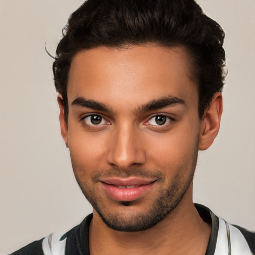 Joyful latino young-adult male with short  brown hair and brown eyes