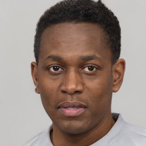 Neutral black young-adult male with short  black hair and brown eyes