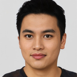 Joyful asian young-adult male with short  black hair and brown eyes