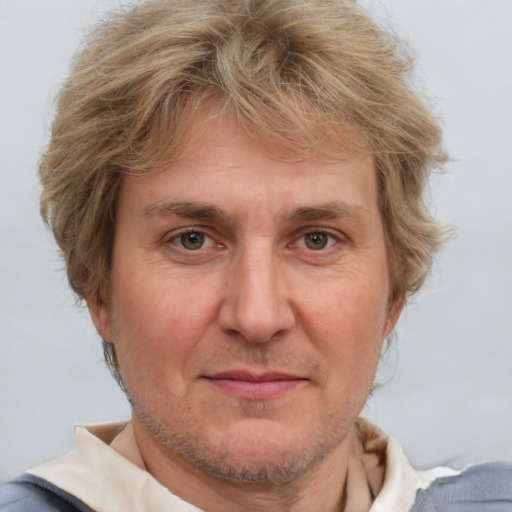 Joyful white adult male with short  brown hair and grey eyes