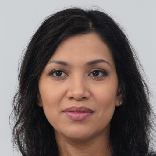 Joyful latino young-adult female with long  black hair and brown eyes