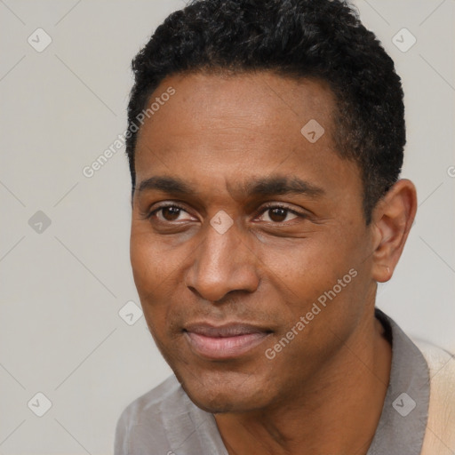 Joyful black adult male with short  black hair and brown eyes