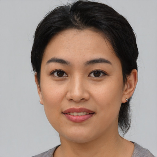 Joyful asian young-adult female with medium  black hair and brown eyes