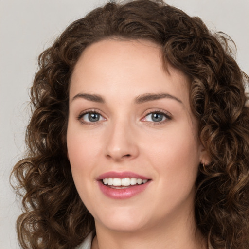 Joyful white young-adult female with medium  brown hair and green eyes