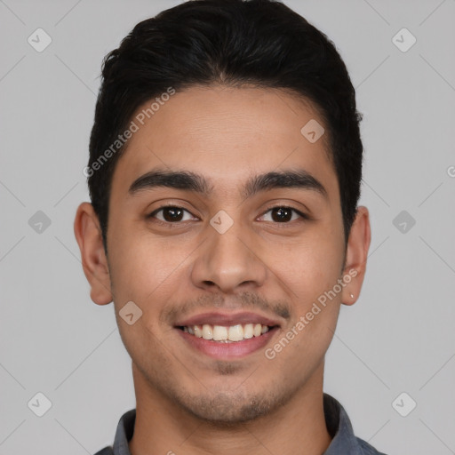 Joyful white young-adult male with short  black hair and brown eyes