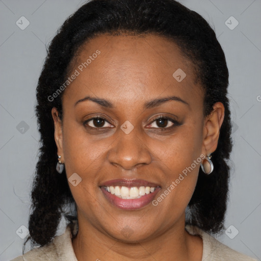 Joyful black adult female with medium  brown hair and brown eyes