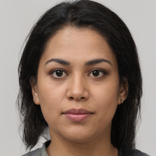 Joyful latino young-adult female with long  brown hair and brown eyes