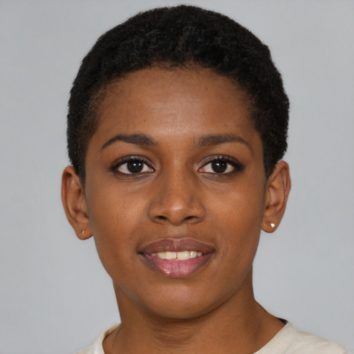 Joyful black young-adult female with short  brown hair and brown eyes