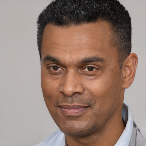Joyful latino adult male with short  black hair and brown eyes