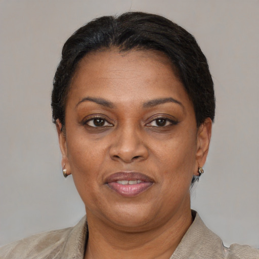 Joyful black adult female with short  black hair and brown eyes