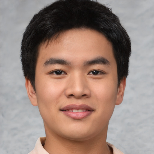 Joyful asian young-adult male with short  black hair and brown eyes