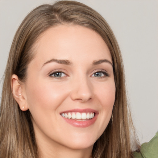 Joyful white young-adult female with long  brown hair and grey eyes