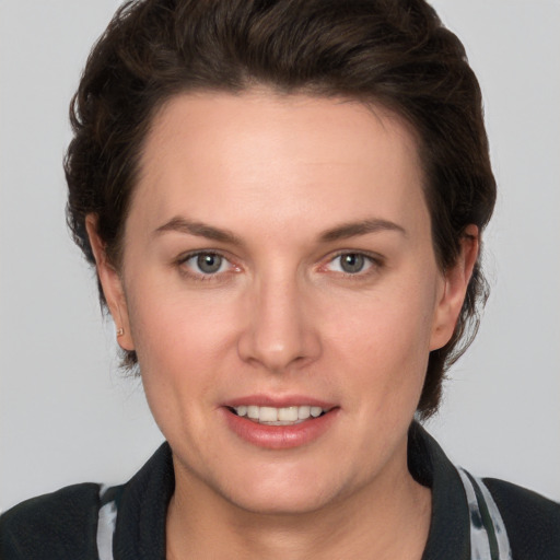 Joyful white young-adult female with medium  brown hair and grey eyes