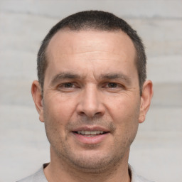 Joyful white adult male with short  brown hair and brown eyes