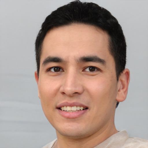 Joyful white young-adult male with short  black hair and brown eyes