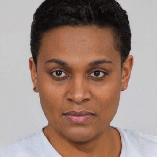 Joyful black young-adult female with short  brown hair and brown eyes