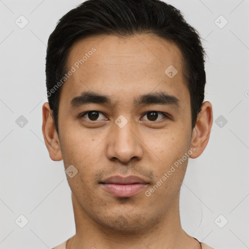 Joyful latino young-adult male with short  brown hair and brown eyes