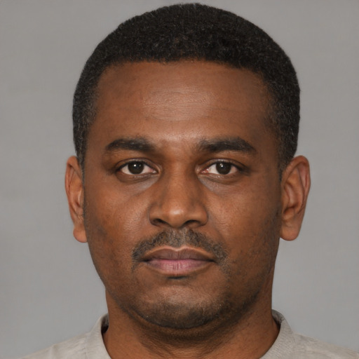 Neutral black young-adult male with short  black hair and brown eyes