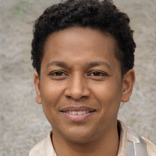 Joyful black young-adult male with short  brown hair and brown eyes