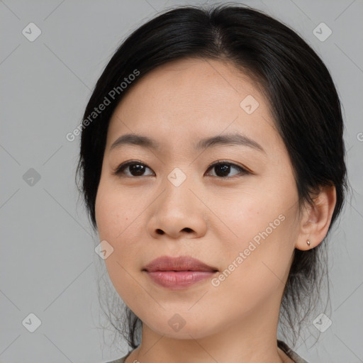 Joyful asian young-adult female with medium  black hair and brown eyes